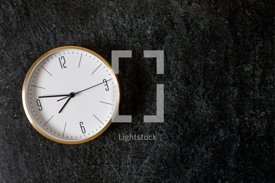 clock against a black background 