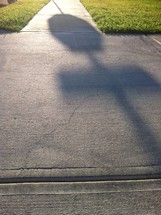 shadow of a stop sign on a sidewalk