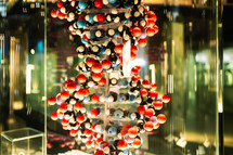 Close-up view of DNA model, structure with lot of colorful balloons on green background. High quality photo
