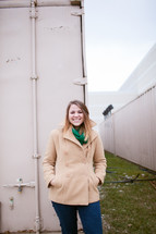 woman in coat standing in front of a storage bin