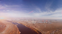 aerial view over a river and distant community 