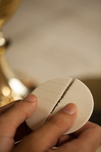 breaking a wafer at communion 
