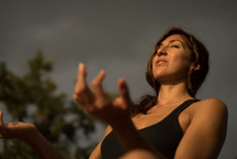a woman meditating outdoors 
