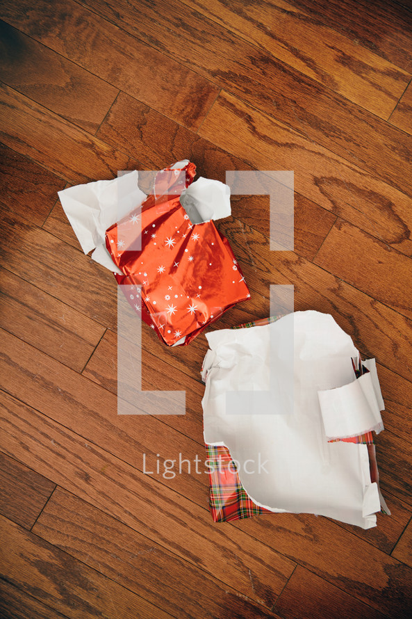 torn wrapping paper on the floor 