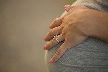 a woman displaying an engagement ring on her hand 