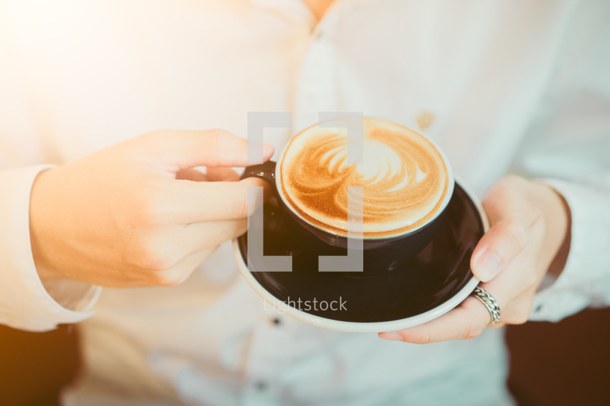 man holding a latte 