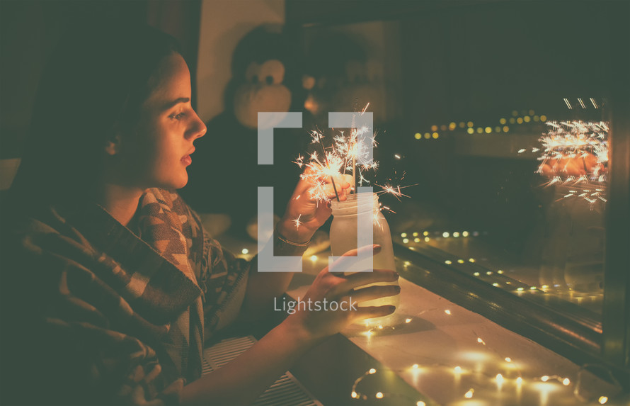 young woman who lights fireworks at home