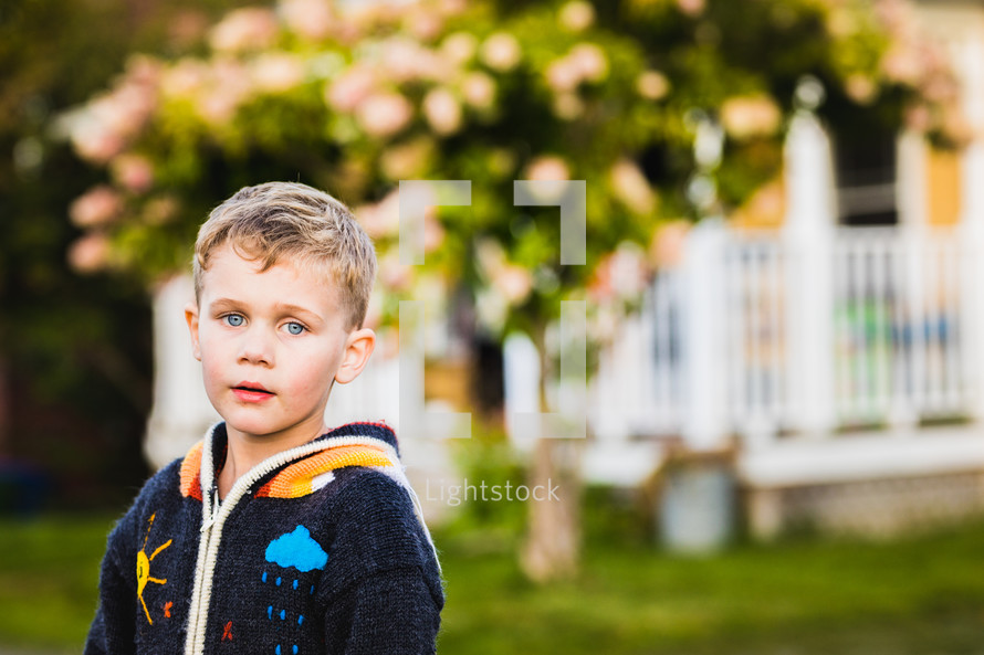 boy outdoors in a sweater 