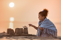 a girl sitting on a beach 