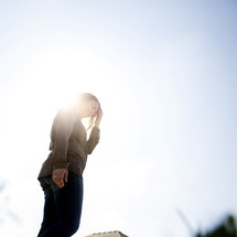 a woman looking away from blinding sunlight 