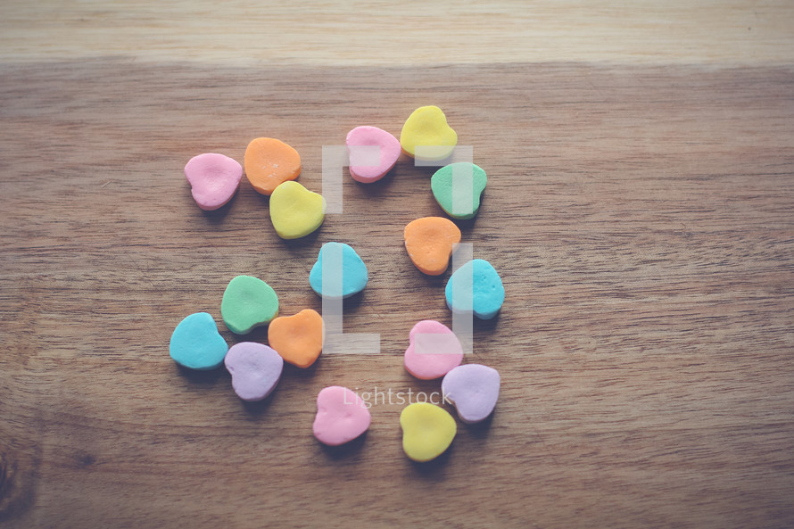 heart shaped candy in the shape of a heart on wood 