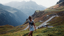 a woman walking on a mountaintop 