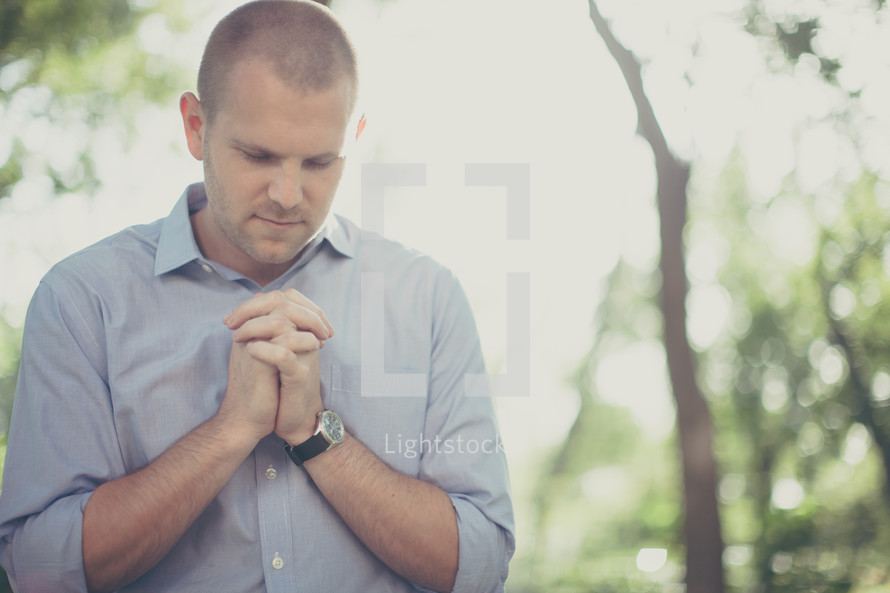 Man praying outside.