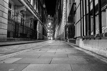 sidewalk in a city at night 