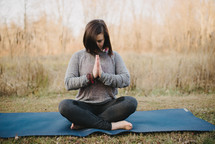 a woman doing yoga outdoors 