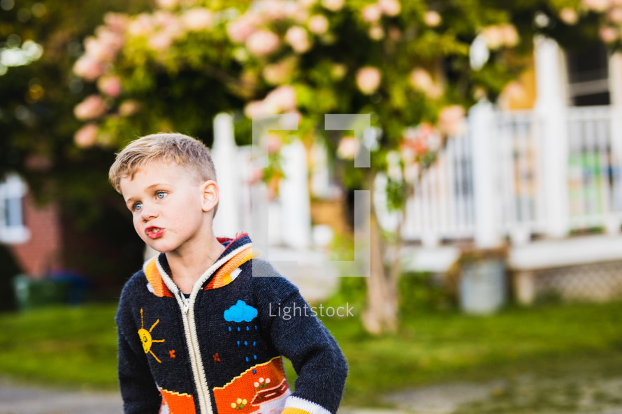 boy outdoors in a sweater 