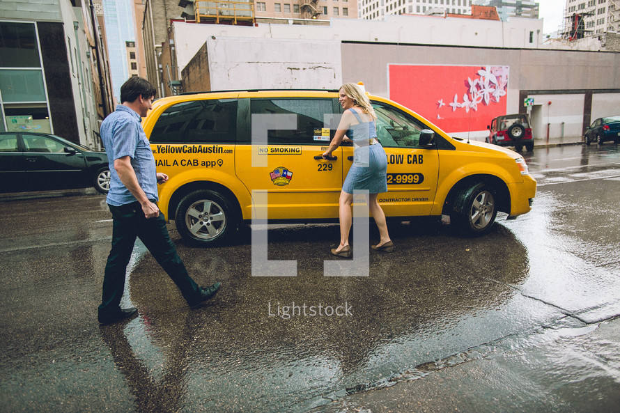 A couple catching a taxi. 