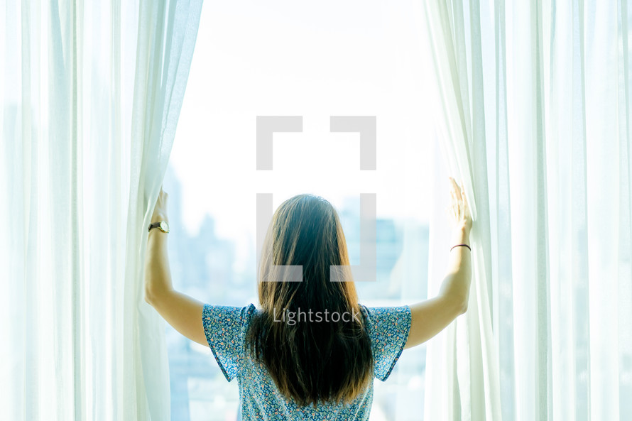 a woman looking out a window 