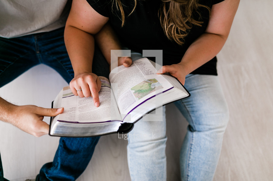 a couple reading a Bible together 