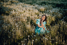 Retro styled woman on fluffy dandelions field, amazing fantasy portrait. Romantic elegant lady with straw hat on nature. Vintage aesthetic lifestyle, floral background. High quality photo