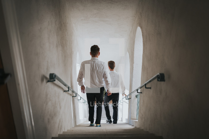 groomsmen walking down a stairwell 