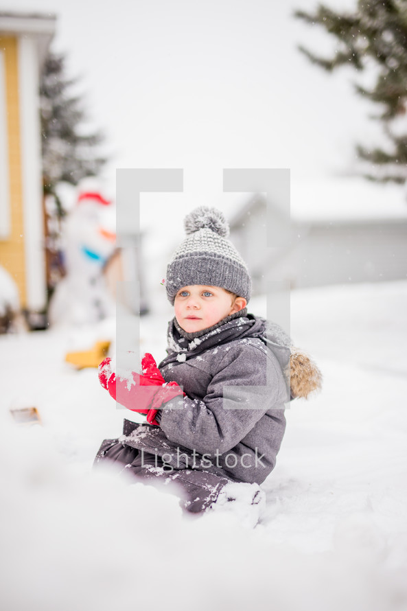  a boy playing in snow 