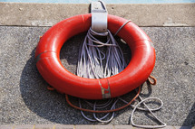 Life ring, lifeboat, lifesaver or reduce ring against concrete wall