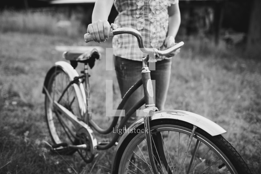 Girl walking bicycle
