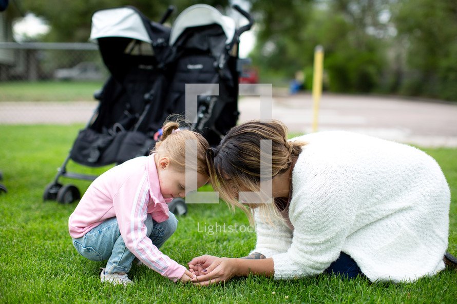 Mother and daughter discovering a bug together 