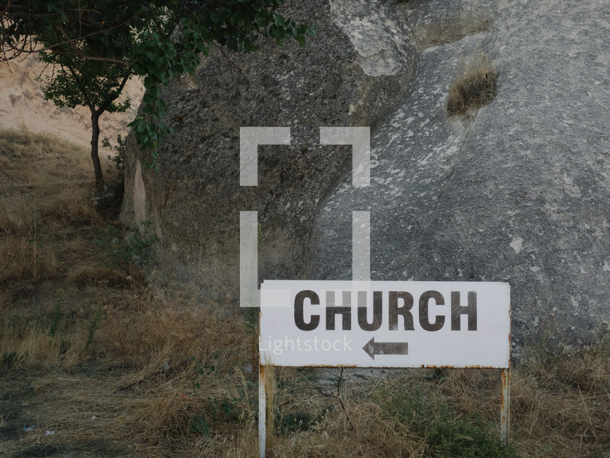 sign pointing the way to a church 