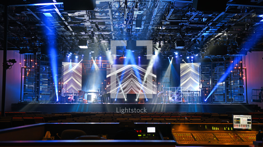 Stage lights shining on an empty stage.
