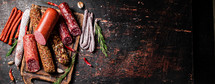 Assortment of various aromatic salami sausages. Against a dark background. High quality photo