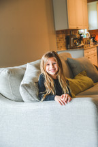 smiling girl sitting on a couch 