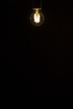 glowing filaments from lightbulbs in darkness 