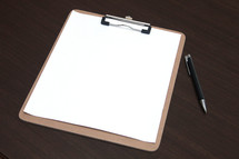 blank clipboard and a pen 