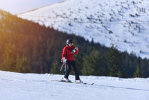 Woman Skier Snaps Photo While Shredding the Mountain