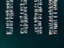 Drone photograph of boats and yachts moored at a marina, sailing and yacht mooring, blue water sea ocean photograph
