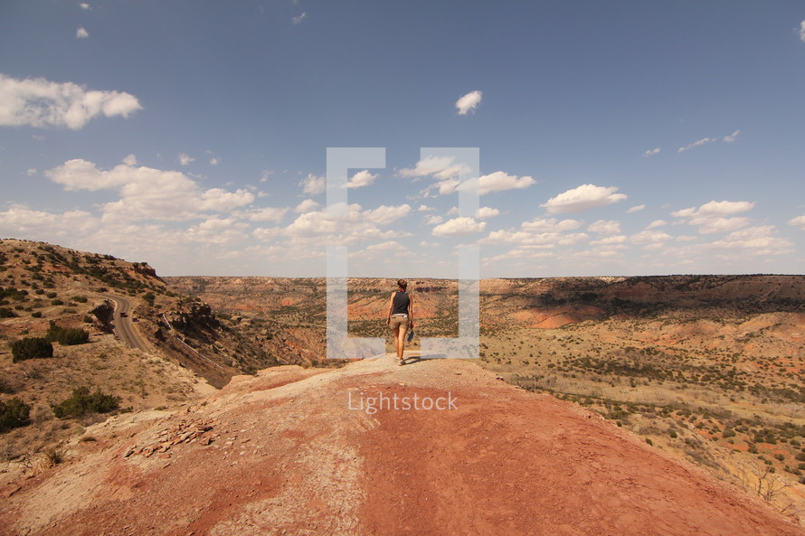 a woman hiking a desert landscape 