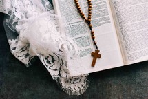 wooden rosary beads on a Bible 