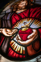 Close up of stained glass window of Flaming Sacred Heart. 