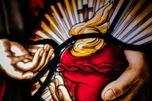 Close up of stained glass window of Flaming Sacred Heart.