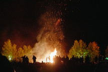 people gathered around a bonfire 