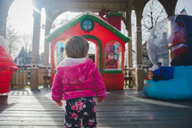 toddler looking at an outdoor Christmas display 