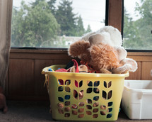 laundry basket full of stuffed animals 
