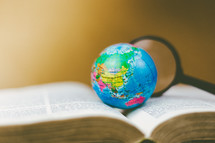 globe on the pages of a Bible 