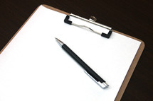 blank clipboard and pen 