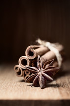 cinnamon and anise on wooden table with blurred background