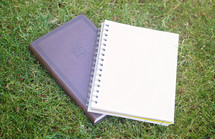 Bible and journal in grass 