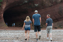 people exploring a large cave 