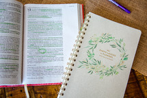 open Bible with highlighted scripture and notebook 